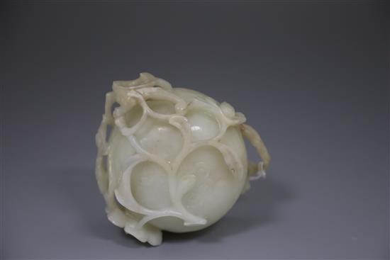 A Chinese pale celadon jade lotus cup, late Ming dynasty, W.13cm, associated wood stand